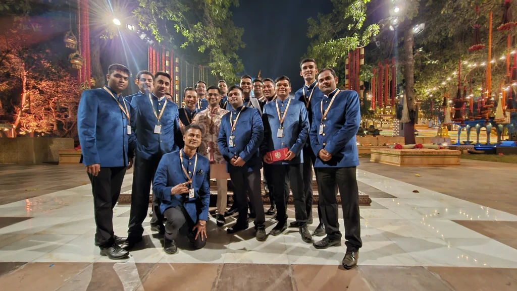 Butler team in blue uniforms at an illuminated wedding venue